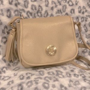 Has a tassel decoration and an adjustable strap.